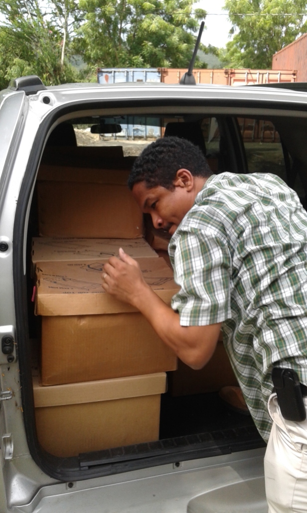 Mr Mock Yen unloading new accessions upon arrival at the Archives