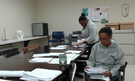 Ms Lyons & Mrs Moseley-Barrett (of the Office of Administration) processing Committee Minutes and Papers